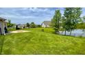 Expansive lawn overlooking a scenic lake, enhanced by a secure black chain-link fence at 994 Young'S Creek Dr, Franklin, IN 46131