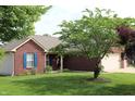 Brick exterior home with an attached garage is complemented by well-manicured lawn at 994 Young'S Creek Dr, Franklin, IN 46131