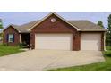 Brick home features an attached two-car garage with a well-maintained lawn at 994 Young'S Creek Dr, Franklin, IN 46131