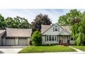 Inviting single-story home with a lush green lawn, a two car garage and well kept exterior at 1101 E Loretta Dr, Indianapolis, IN 46227