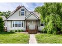 Close-up of cozy single-story home featuring a charming front porch with stained wooden steps and columns at 1101 E Loretta Dr, Indianapolis, IN 46227