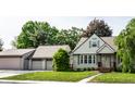 Beautiful single-story home with a well-manicured lawn, a two car garage and landscaped front at 1101 E Loretta Dr, Indianapolis, IN 46227