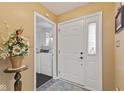 Bright entryway features a stylish front door and convenient access to the laundry room at 1124 Enchanted View Dr, Mooresville, IN 46158