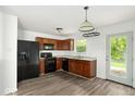 Well-lit eat-in kitchen with black appliances, laminate floors, and access to the backyard at 11821 Wapiti Way, Noblesville, IN 46060