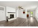 Bright living room featuring a fireplace, ceiling fan, and durable laminate flooring throughout the home at 11821 Wapiti Way, Noblesville, IN 46060