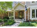 Inviting brick entryway with a charming front door, surrounded by lush greenery and flowers at 12335 Old Stone Dr, Indianapolis, IN 46236