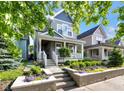 Charming exterior view of a two-story home with a welcoming front porch and landscaped garden at 1322 Marlowe Ave, Indianapolis, IN 46202