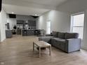 Open living area featuring wood floors, natural light, a gray sectional couch and an eat-in kitchen at 1518 S Talbott St, Indianapolis, IN 46225