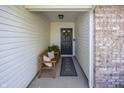 Inviting front porch features a cozy bench and decor, leading to an elegant entryway at 15388 Follow Dr, Noblesville, IN 46060
