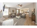 Bright and open living room with hardwood floors, a large sectional, and access to the kitchen at 15388 Follow Dr, Noblesville, IN 46060