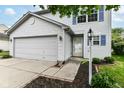 Front exterior of a well maintained two-story home with landscaped garden at 15411 Wandering Way, Noblesville, IN 46060