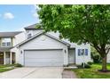 Traditional two-story home with a gray garage door and light-blue shutters at 15411 Wandering Way, Noblesville, IN 46060
