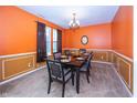 Elegant dining room with wainscoting, a stylish chandelier, and a well-set table at 15710 Chapel Park E Dr, Noblesville, IN 46060