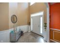 Bright foyer with high ceilings, tiled floors, and elegant decor, showcasing a welcoming entrance at 15710 Chapel Park E Dr, Noblesville, IN 46060