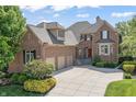 Charming brick home with a three-car garage and manicured lawn at 16502 Grand Cypress Dr, Noblesville, IN 46060