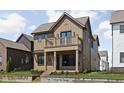 Charming two-story home featuring a welcoming porch and upper balcony, complemented by neatly landscaped surroundings at 1664 Carrollton Rail Dr, Westfield, IN 46074