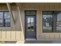 Close up of front door with side windows and the reflection of neighborhood buildings at 1664 Carrollton Rail Dr, Westfield, IN 46074