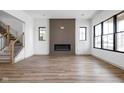 Bright living room featuring a modern fireplace, large windows, and elegant hardwood flooring, creating a cozy atmosphere at 1664 Carrollton Rail Dr, Westfield, IN 46074