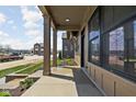Covered front porch with elegant support columns and view of the manicured front lawn at 1664 Carrollton Rail Dr, Westfield, IN 46074