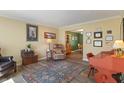 Cozy living room with hardwood floors, area rug, and access to the dining room at 24 Cinnamon Ct, Brownsburg, IN 46112