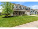 Charming two-story home with a well-maintained lawn, brick accents and a beautiful shade tree at 2626 Solidago Dr, Plainfield, IN 46168