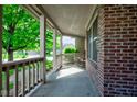 Covered front porch featuring a brick wall and a rocking chair, perfect for relaxing outdoors at 286 N Greenbriar Dr, Greenwood, IN 46142