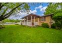 A charming home with a covered porch and well-maintained landscaping provides curb appeal at 2900 Helms Rd, Anderson, IN 46016