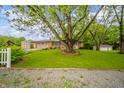 Attractive brick home featuring a covered porch, attached garage, and a well-manicured lawn at 2900 Helms Rd, Anderson, IN 46016