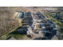 Aerial view of a new residential development with single-Gathering homes and a water feature at 331 Oxford Ln, Lebanon, IN 46052