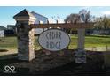 Stone pillars support the Cedar Ridge community sign with fresh landscaping in a newly developed neighborhood at 331 Oxford Ln, Lebanon, IN 46052