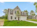 Charming two-story home featuring brick and vinyl siding, a two-car garage, and a well-kept lawn at 331 Oxford Ln, Lebanon, IN 46052