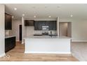 Stylish kitchen with granite counters, dark cabinets, stainless appliances, and an island, open to living space at 331 Oxford Ln, Lebanon, IN 46052