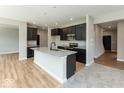Modern kitchen featuring an island with granite countertops, sleek black cabinets, and stainless steel appliances at 331 Oxford Ln, Lebanon, IN 46052