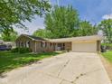 Traditional brick home with attached garage, well maintained lawn, and mature landscaping at 3400 Debra Dr, Anderson, IN 46012