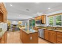 Bright kitchen with granite countertops, stainless steel appliances, a center island with cooktop, and sliding glass doors at 3479 Sugar Loaf Ct, Carmel, IN 46033