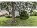 Charming house with a lush green lawn and mature trees in the yard at 454 E Broadway St, Greenwood, IN 46143