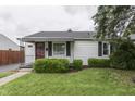 Well-maintained home featuring a lush lawn and charming landscaping at 454 E Broadway St, Greenwood, IN 46143