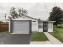 Detached single car garage with extra space for storage and a side door at 454 E Broadway St, Greenwood, IN 46143