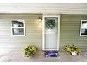 Close up view of covered porch with a tastefully decorated front door at 4910 W Caven St, Indianapolis, IN 46241