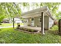 Charming home featuring a cozy covered front porch with fresh landscaping at 4910 W Caven St, Indianapolis, IN 46241