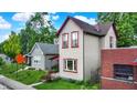 Charming two-story home with light siding, red trim, and lush landscaping in a residential neighborhood at 514 Dorman St, Indianapolis, IN 46202