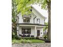 Charming two-story modern farmhouse featuring black window trim and inviting front porch at 5254 N Park Ave, Indianapolis, IN 46220