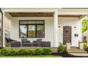 Inviting front porch with seating, stylish lighting, and beautifully landscaped surroundings at 5254 N Park Ave, Indianapolis, IN 46220