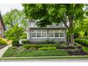 Charming two-story home with beautiful landscaping and mature trees at 5430 N Washington Blvd, Indianapolis, IN 46220