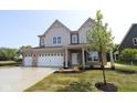 Two-story home features a three-car garage and newly installed grass and landscaping at 5517 Sienna Ct, Brownsburg, IN 46112