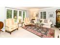 Bright living room featuring large windows with plantation shutters and classic furniture at 6530 Lowanna Way, Indianapolis, IN 46220