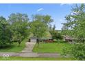 An aerial view of the home showcasing the landscaping, metal roof, and neighborhood at 679 Bark Dr, Anderson, IN 46011