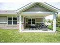 The covered patio is perfect for outdoor relaxation with comfortable seating and views of the lush lawn at 695 Overcup St, Westfield, IN 46074