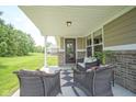 Relax on this covered patio that provides ample seating space and a tranquil outdoor experience at 695 Overcup St, Westfield, IN 46074