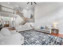 Bright living room featuring hardwood floors, a staircase, and modern décor at 7022 Tamarind Ct, Indianapolis, IN 46236